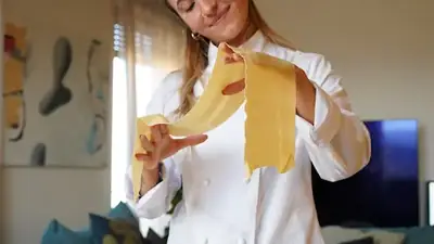 Private chef holding pasta sheet