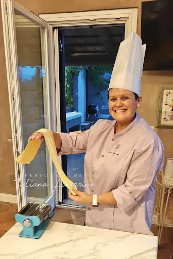 Private chef smiling chef pasta machine